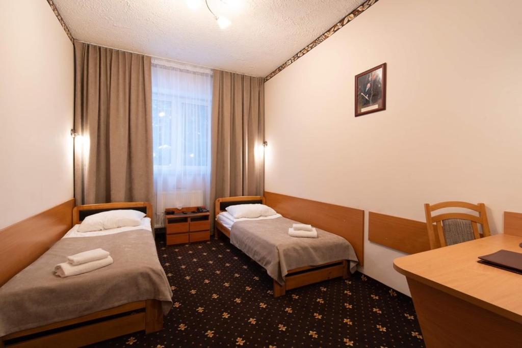 Postel nebo postele na pokoji v ubytování Hotel Trylogia