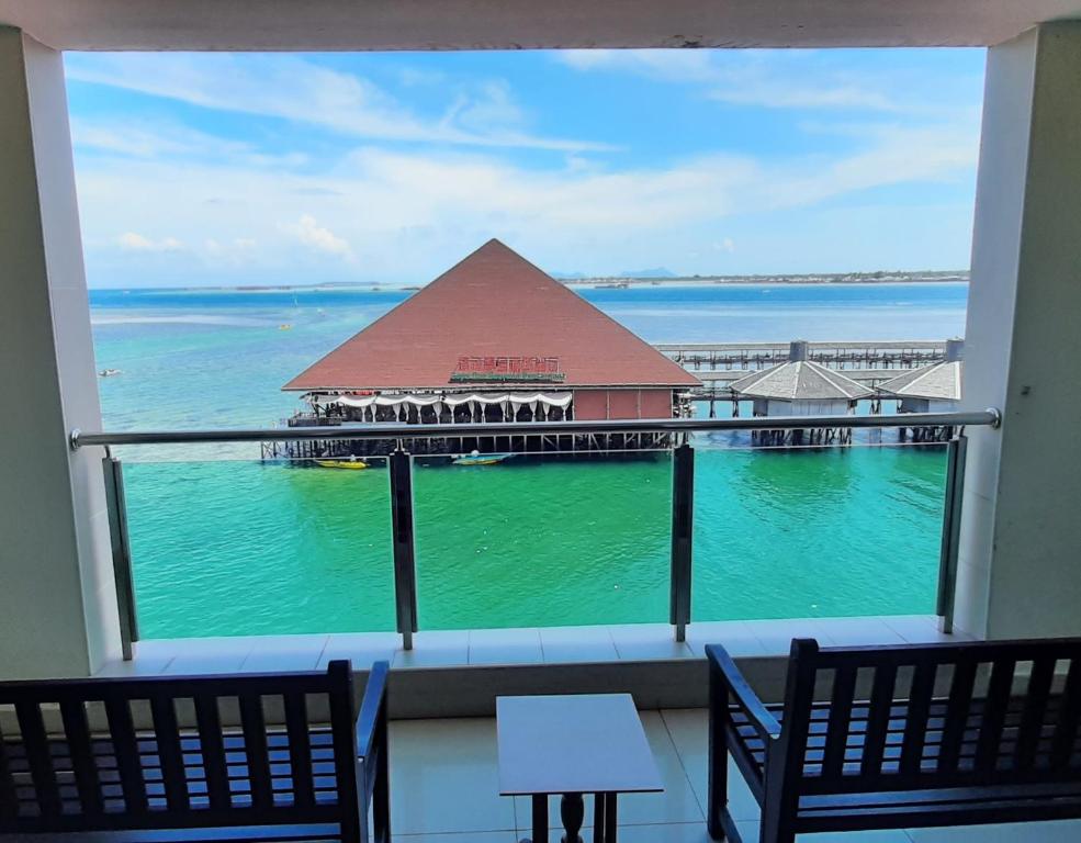 a view of a pier from a hotel window at Sipadan Inn Service Apartments Semporna in Semporna