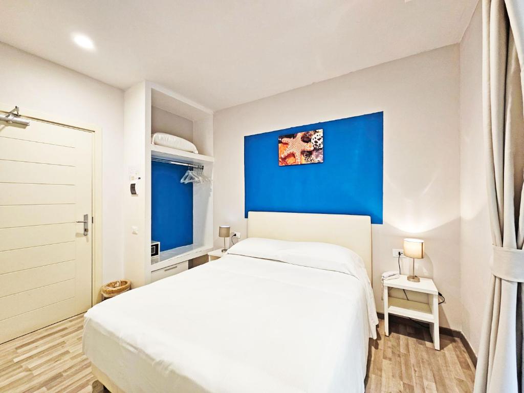 Łóżko lub łóżka w pokoju w obiekcie Hotel l'Approdo