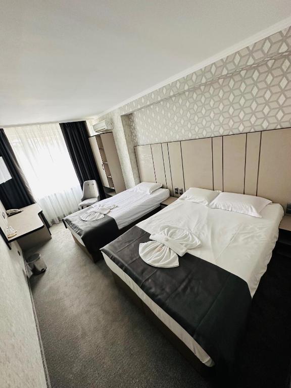 Postel nebo postele na pokoji v ubytování Hotel Cosmos