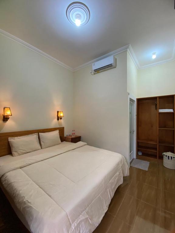 Postel nebo postele na pokoji v ubytování Maher House Borobudur