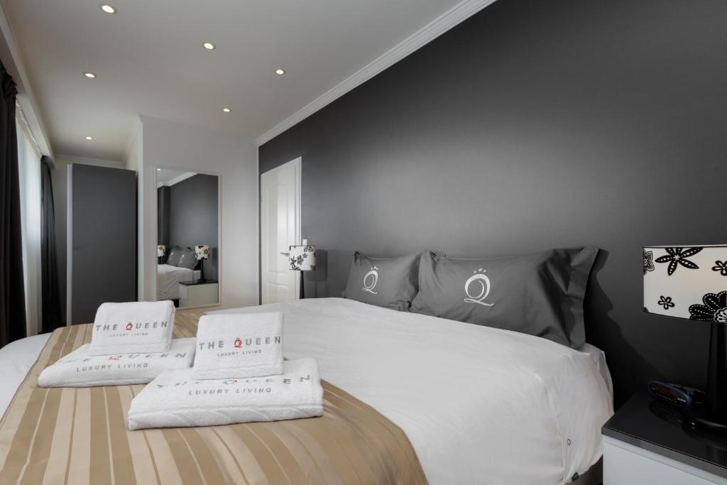 a bedroom with a bed with two pillows on it at The Queen Luxury Apartments - Villa Fiorita in Luxembourg