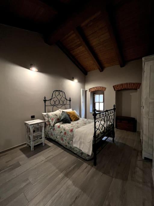 a bedroom with a bed and a table in a room at Il Sulé in Giaveno