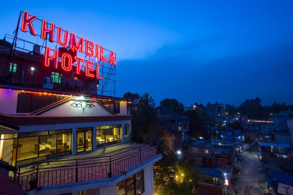 a neon sign on top of a building at night at Khumbila Hotel in Kathmandu