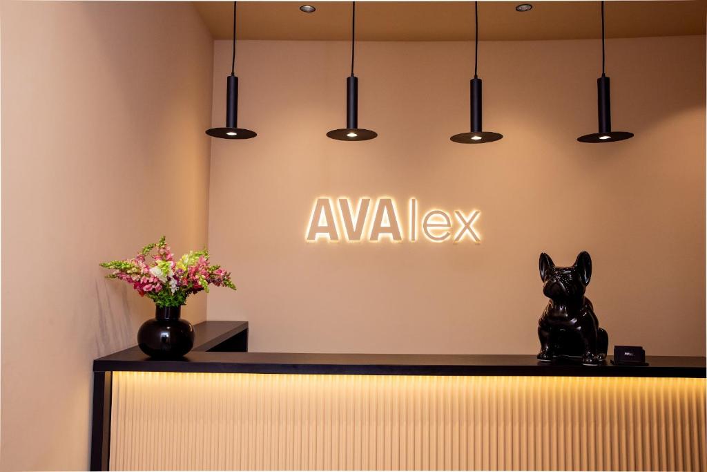a lobby with a sign that says awake with a dog statue at Hotel AVAlex in Berlin