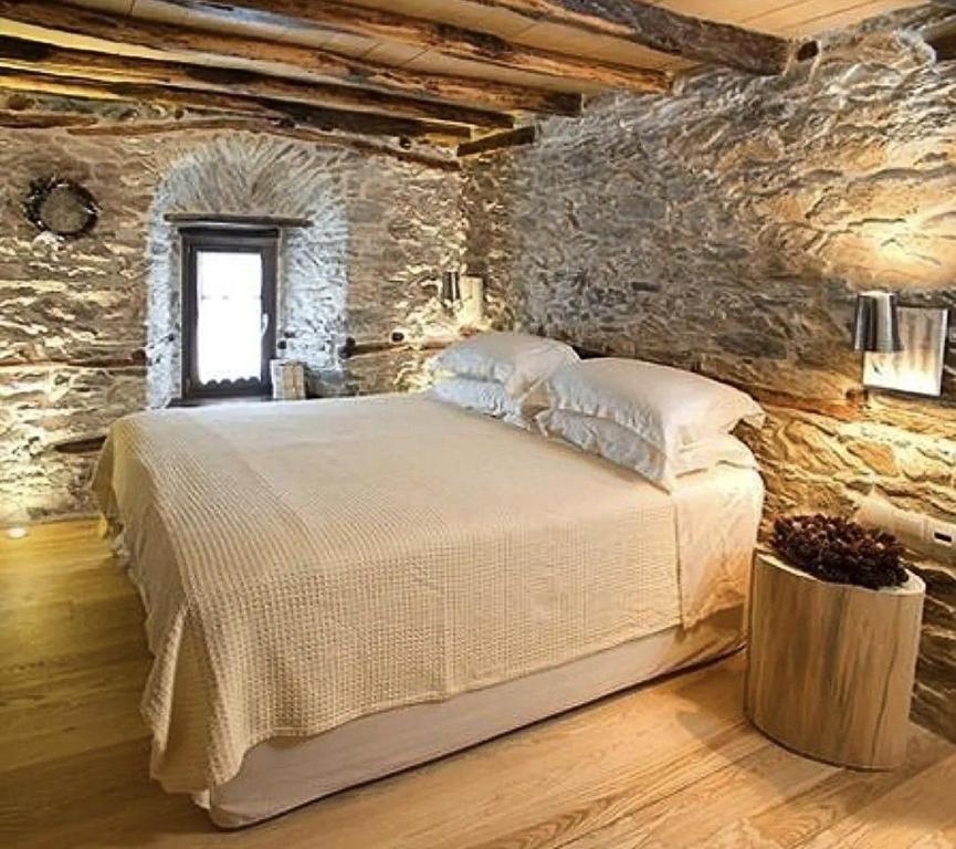 a bedroom with a bed in a stone wall at milenyum travel in Şile