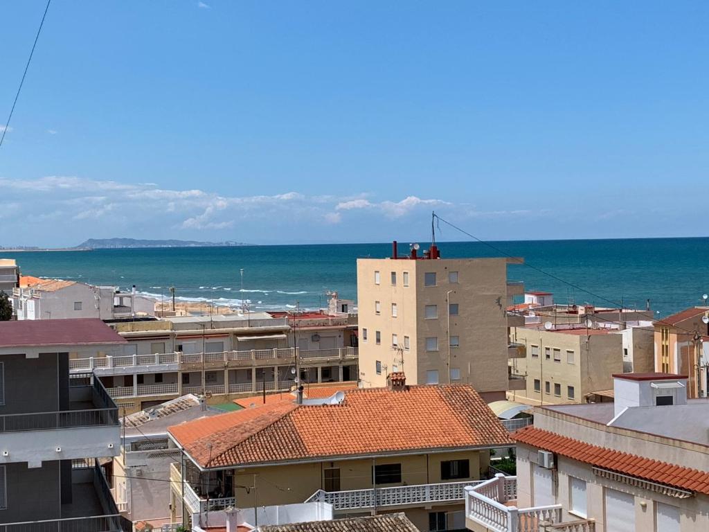 a view of a city with the ocean in the background at NEW UDYNO in Piles
