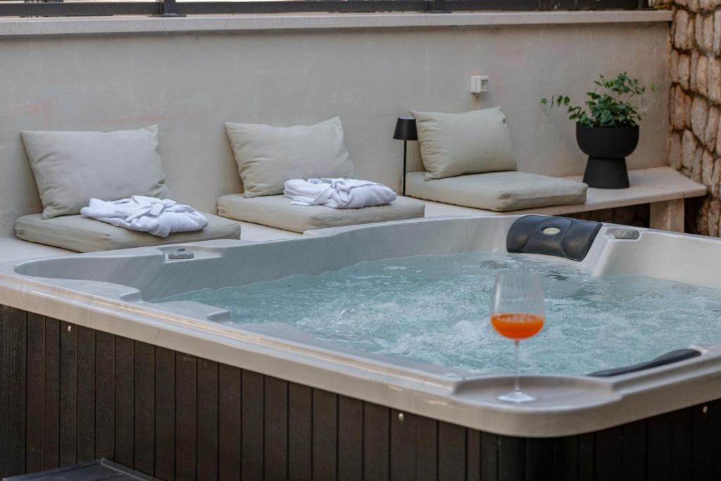 a hot tub with a glass of wine in it at Apartment Barbara with Private pool in Dubrovnik