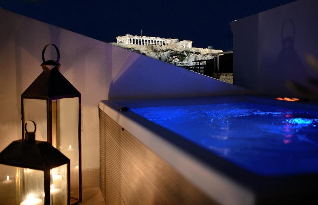 a swimming pool on the side of a building at night at Luxury Athens Apartment | 2 Bedrooms | Apartment Mavis | Spacious Terrace with Hot Tub and Stunning City Views | Athinaidos in Athens
