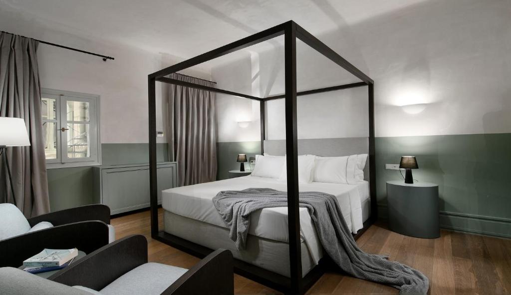 1 dormitorio con cama con dosel y sala de estar. en Stunning Athens Apartment | 1 Bedroom | Apartment Juvia | Athinaidos en Atenas