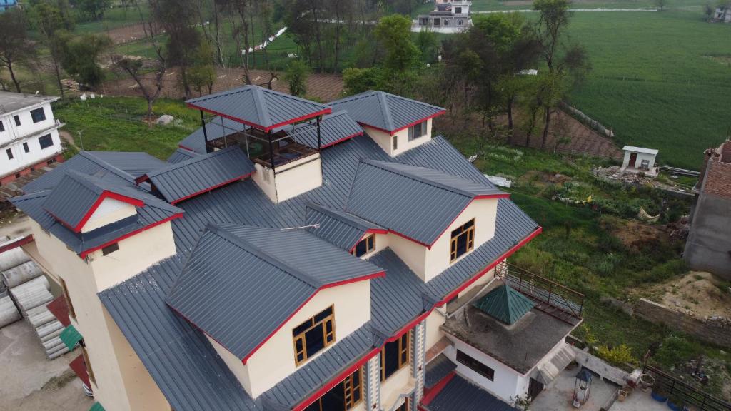 an overhead view of a house with grey roof at Hotel CM Palace - Pure Vegetarian 