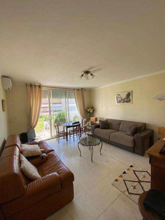 un salon avec un canapé et une table dans l'établissement 3 Pièces avec grande terrasse, à Cannes