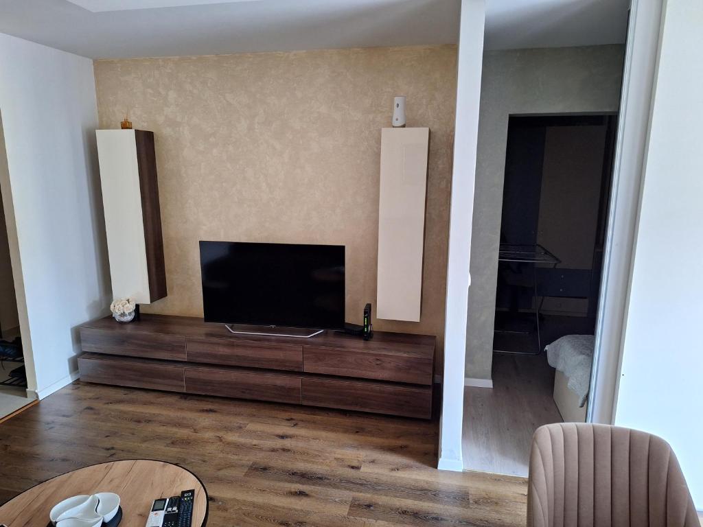 a living room with a flat screen tv on a dresser at Appartment in Zenica