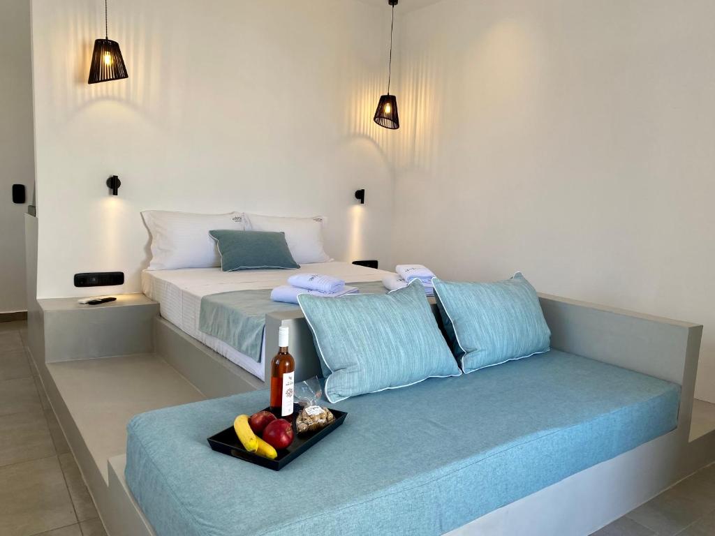 a bedroom with a bed with a tray of fruit at Asteras Mini Suites in Naousa