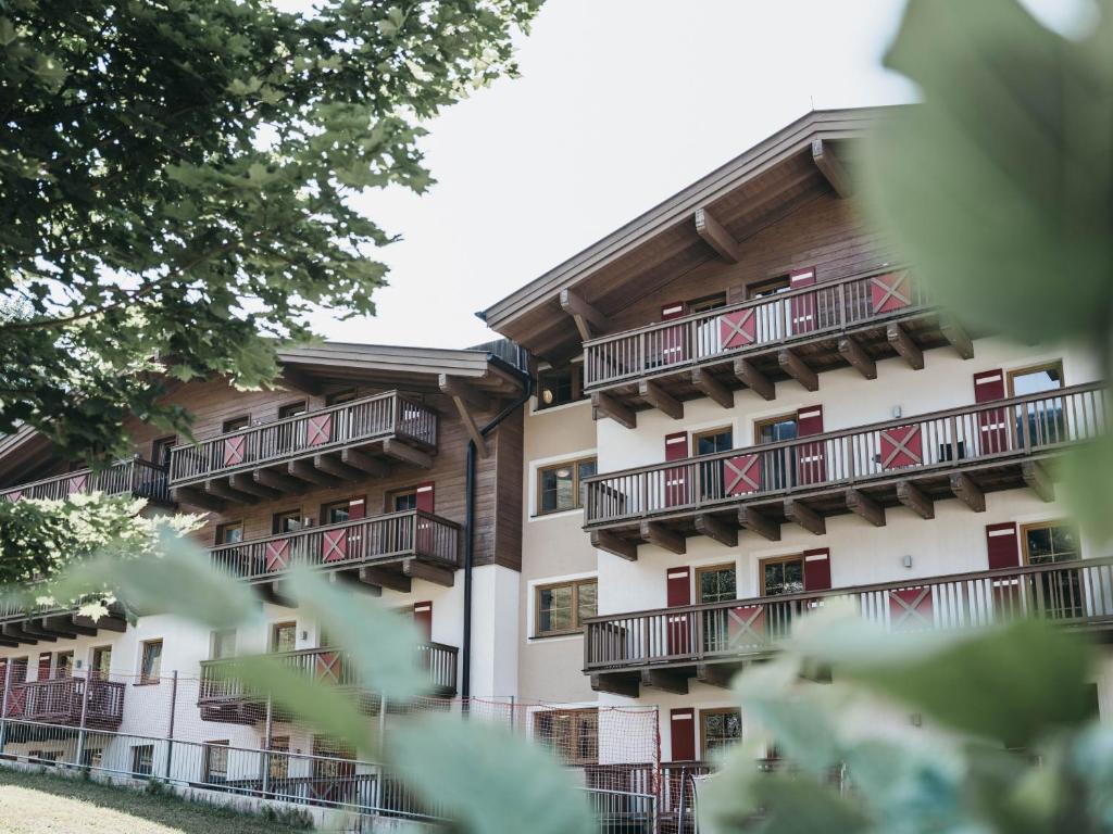 an apartment building with balconies with the american flag at Residence Kristall by VAYA in Saalbach-Hinterglemm