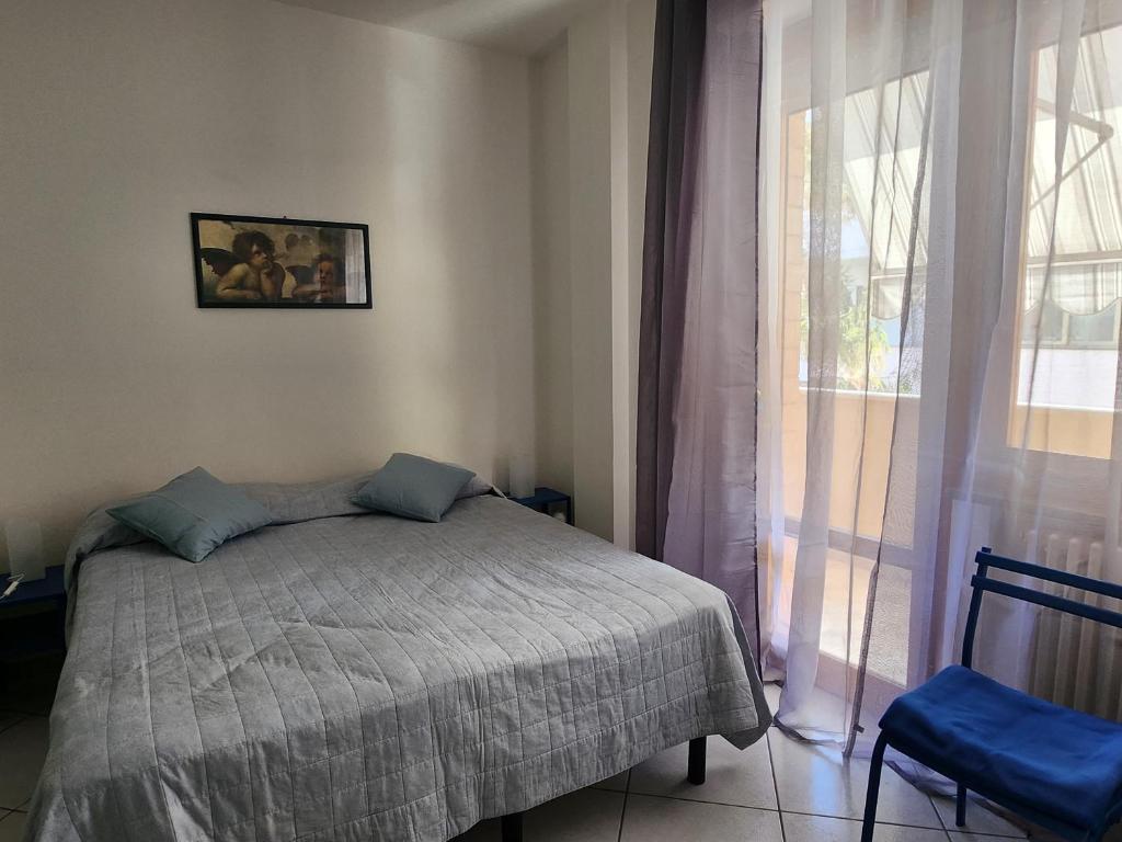 a bedroom with a bed and a window at The Blue Room in Porto SantʼElpidio