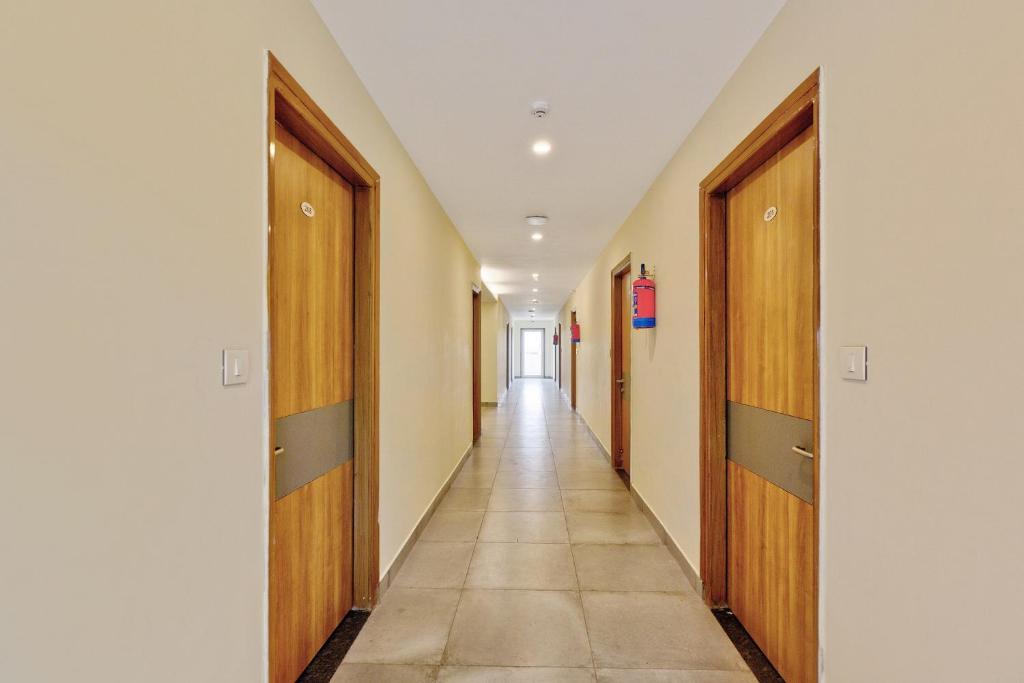 um corredor de um corredor vazio com portas de madeira em Blessings Residency em Rājpur