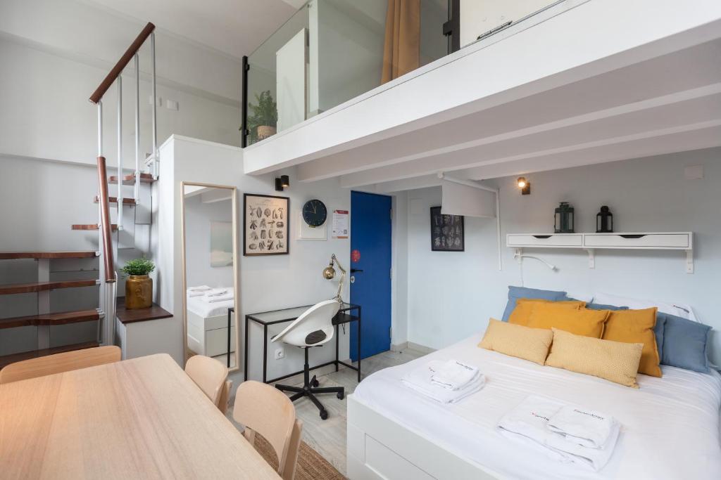 a bedroom with a bed and a desk in a room at FLH Beato Lofts in Lisbon