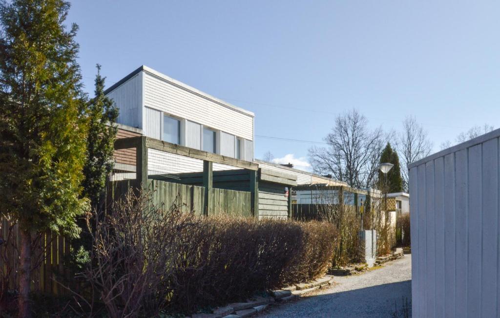 a house with a fence in front of it at 2 Bedroom Amazing Apartment In Skrholmen in Stockholm