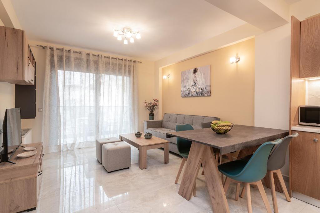 a living room with a dining room table and a couch at Al Centro Zante city flat in Zakynthos
