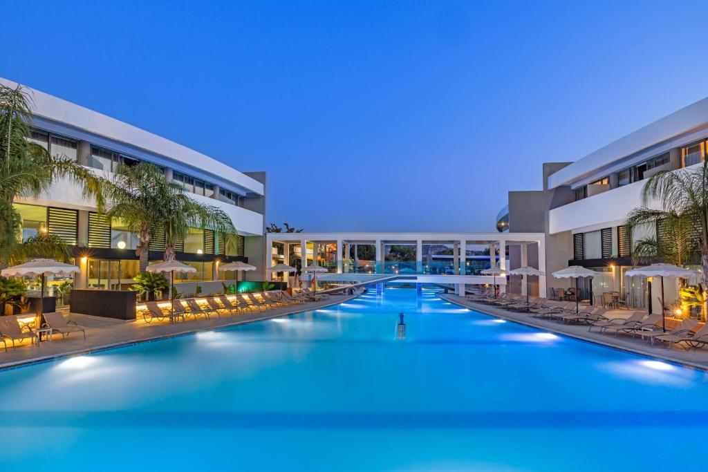 an image of a resort pool at night at Virginia Family Resort in Kallithea Rhodes
