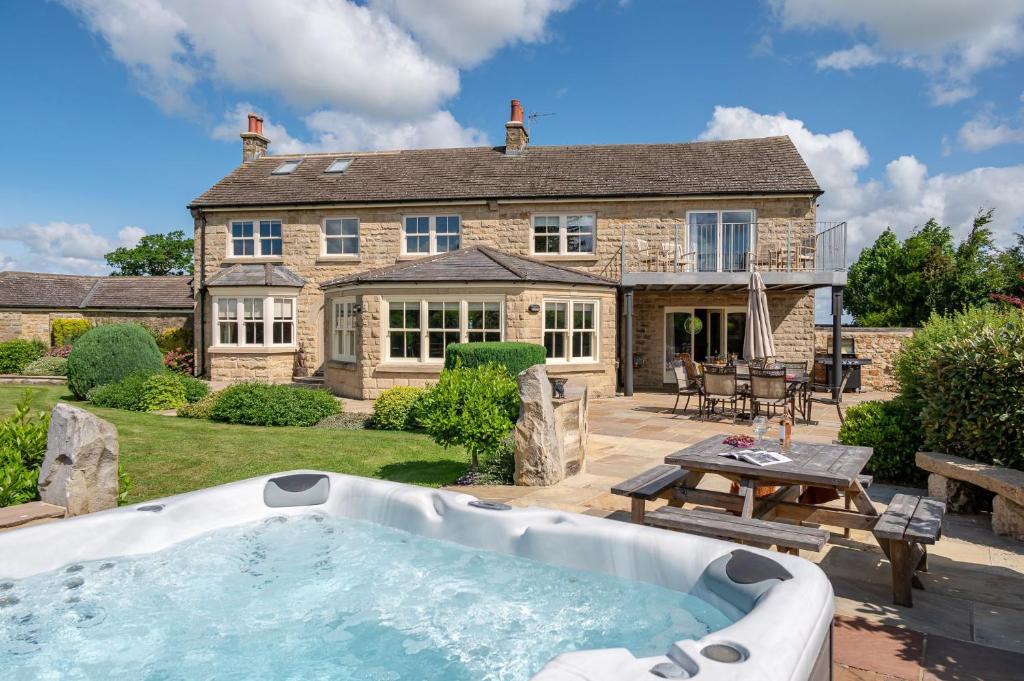 an exterior view of a house with a hot tub at Harelands in Aldbrough