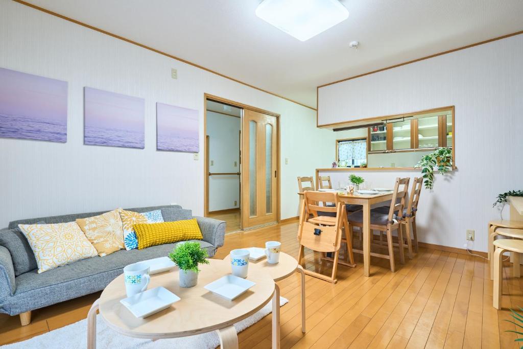 a living room with a couch and a table at Comfy Home Koiwa in Tokyo