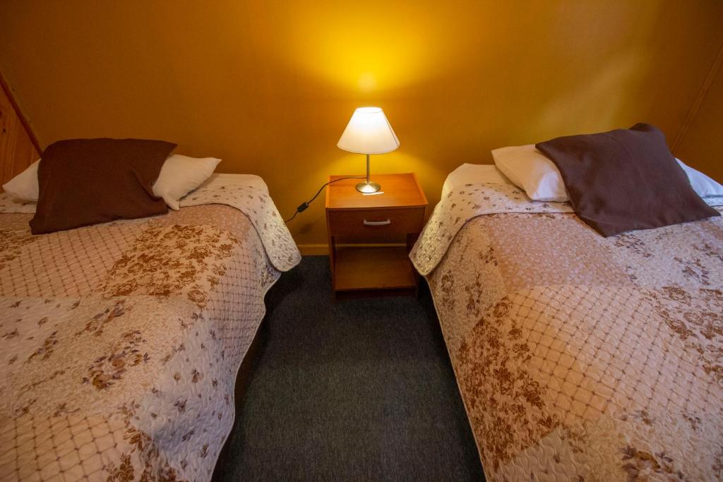 Vuode tai vuoteita majoituspaikassa Apart Hotel y Cabañas Valle Exploradores