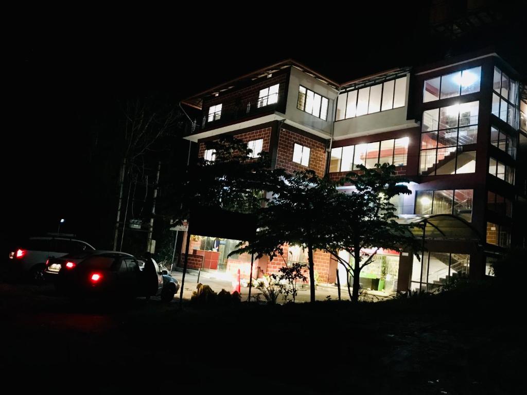 a building at night with a car parked in front at Hotel Chef Knife (Part of Querencia Precinct) in Gonikoppal