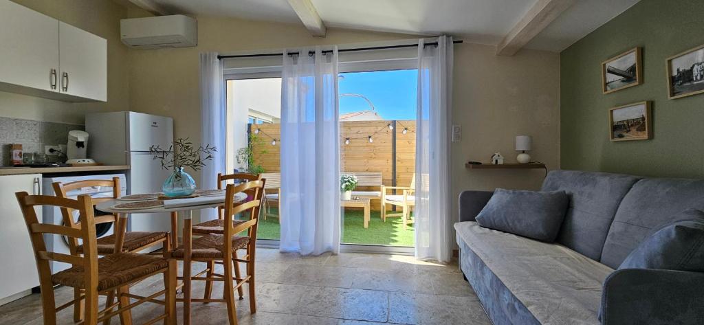 a living room with a couch and a table at Chez Lisa in Saint-Louis-du-Rhône