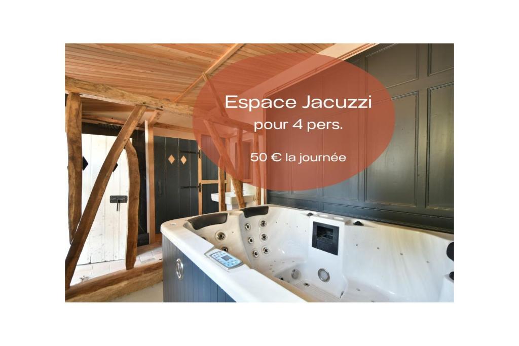 a bathtub in a bathroom with a poster for a house at Plain pied avec terrasse à 5 minutes de Berck in Verton