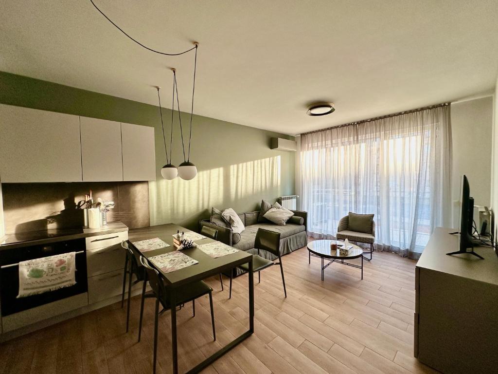 a kitchen and living room with a table and a couch at 7th Sense boutique apartments in Sofia