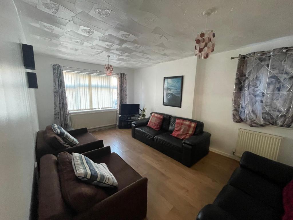 a living room with two couches and a couch at Crompton Haven, Liverpool Accessible Home in Liverpool