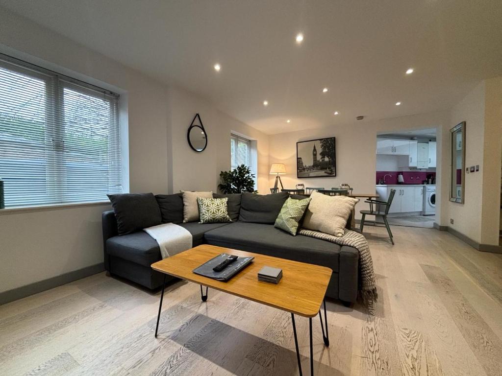 a living room with a couch and a table at School Path Ironbridge Home with Roof Terrace in Ironbridge