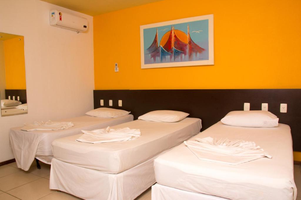 
A bed or beds in a room at Saint Patrick Praia Hotel
