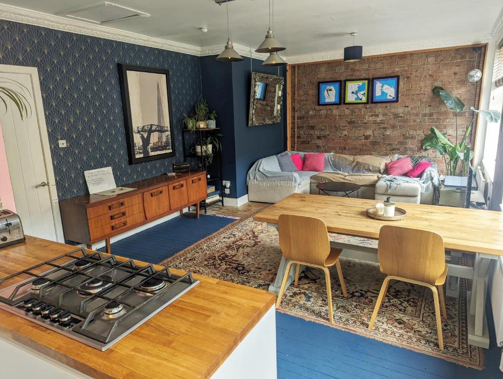 a kitchen and living room with a stove and a table at One The Mews in Glasgow