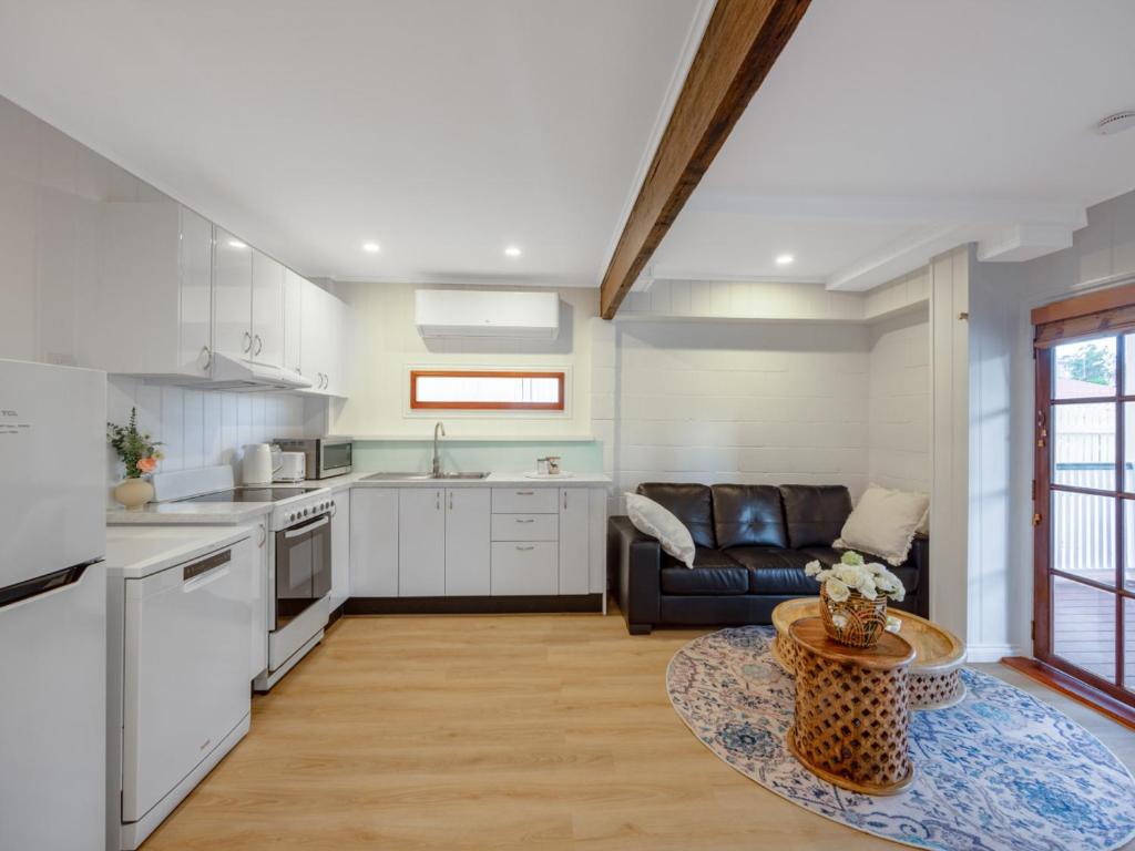 a kitchen and living room with a couch and a table at Serene 3 Bedroom Inner City Retreat Highgate Hill in Brisbane
