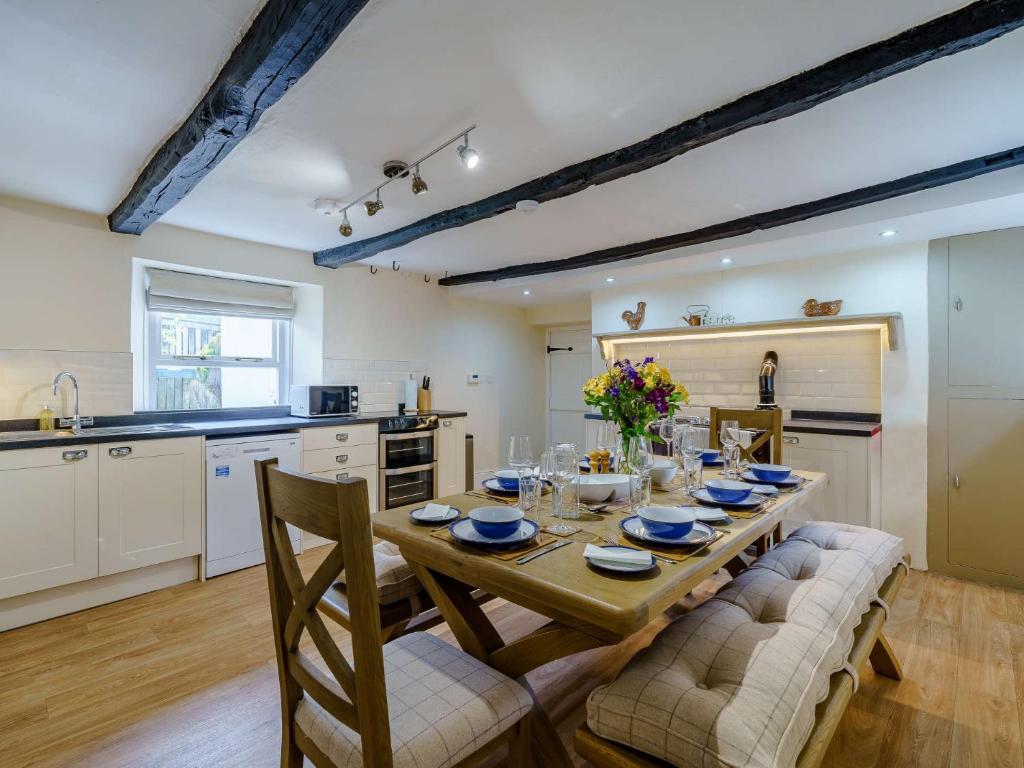 a kitchen and dining room with a table and chairs at 3 Bed in Buttermere 82775 in Buttermere