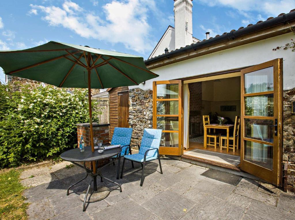 a patio with a table and two chairs and an umbrella at 1 Bed in South Molton LAKVI in South Molton