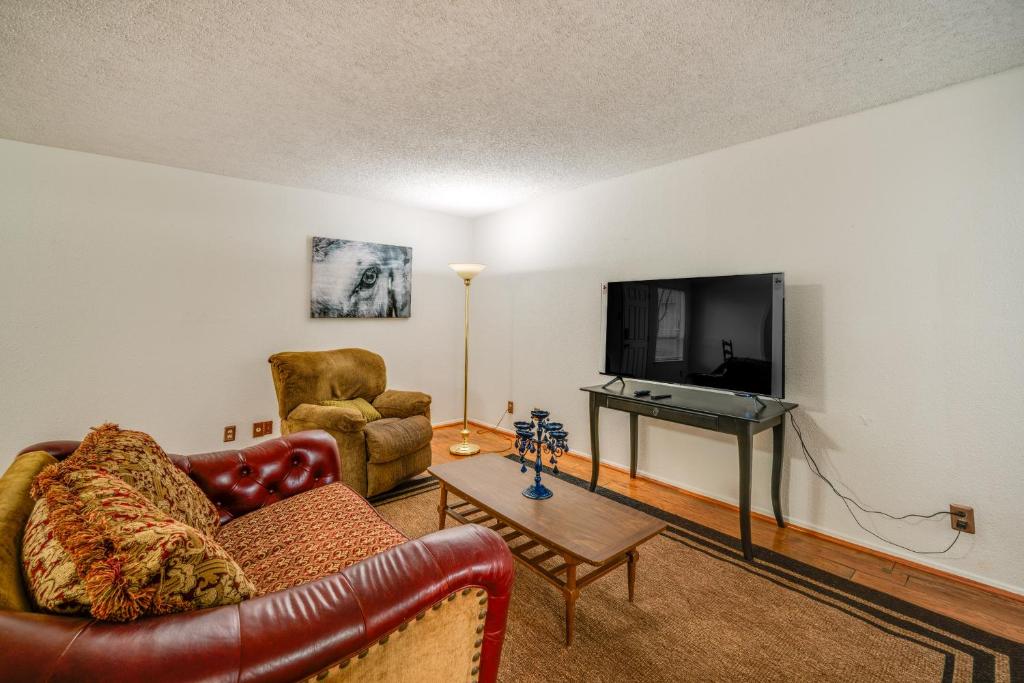 a living room with a couch and a television at Walkable Dallas Condo about 3 Mi to Downtown! in Dallas