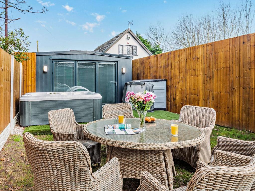 a patio with a table and chairs in a backyard at 2 Bed in Kinmel Bay 94036 in Kinmel Bay
