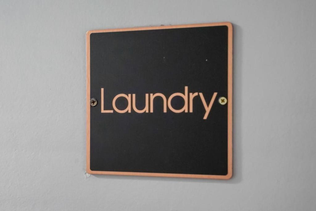a chalkboard with the word laundry written on it at Crystal City Boutique Flats 2BR - Free Parking 204 in Arlington