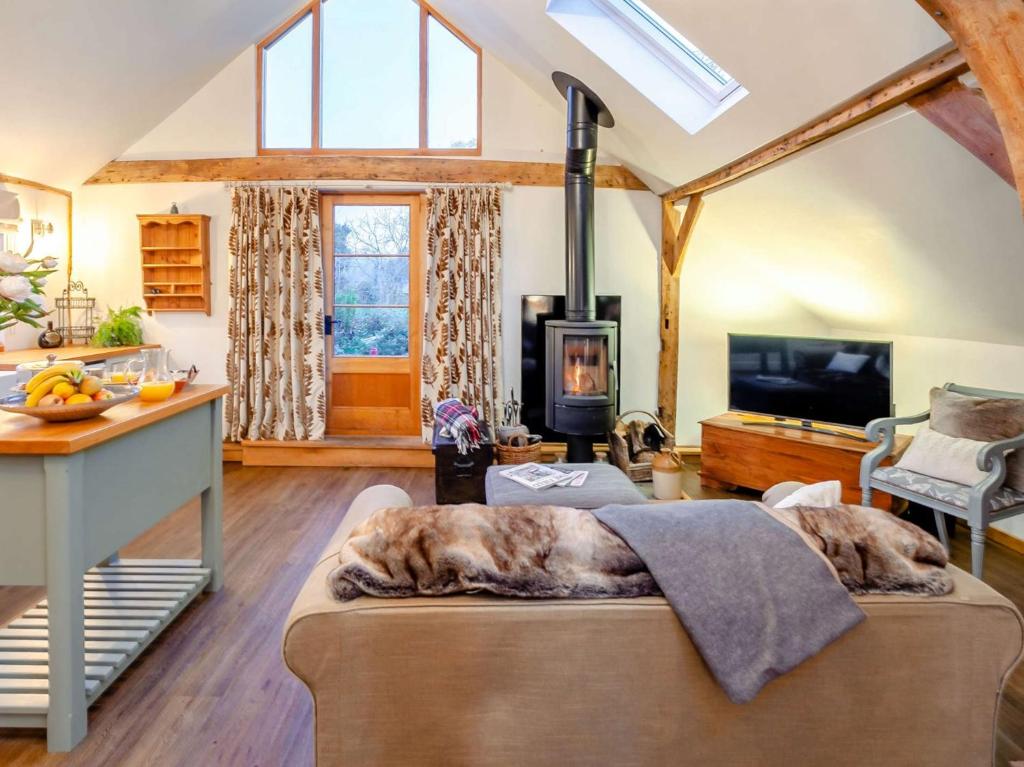 a living room with a dog laying on a couch at 1 Bed in Loxwood 90733 in Loxwood