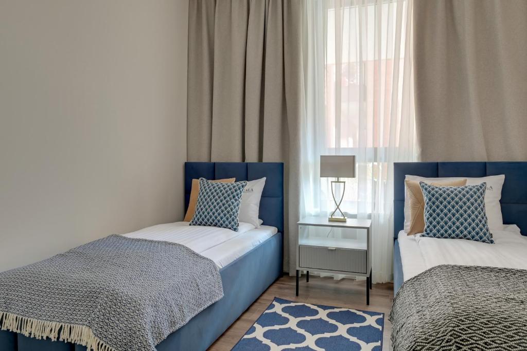Posteľ alebo postele v izbe v ubytovaní Scala City Center Premium Apartments by Lion Apartments