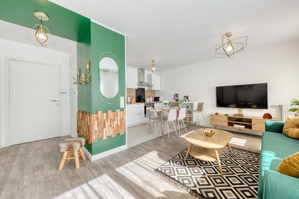 a living room with a couch and a table at 44m² - Cosy - Neuf - Parking in Massy