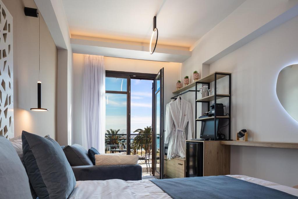 a bedroom with a bed and a view of the ocean at MY Luxury Suites - Old Town Rethymno in Rethymno Town