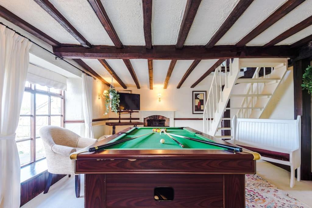 a room with a pool table in a room at Spacious 5BR Home w/Game Room in Ruthin