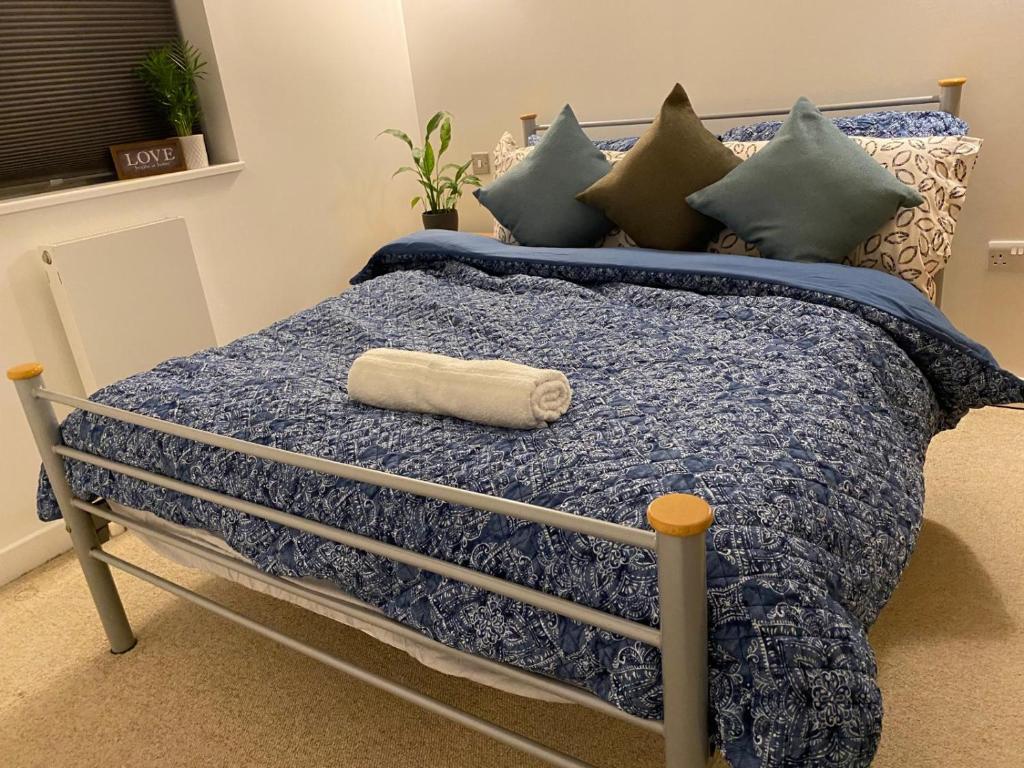 a bed with a towel laying on top of it at North Greenwhich Homestay in London