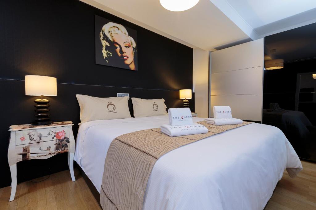 a hotel room with two beds with white sheets at The Queen Luxury Apartments - Villa Marilyn in Luxembourg