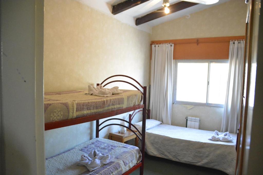ヴィラ・カルロス・パスにあるHotel Bellavistaのベッドルーム1室(二段ベッド2台、窓付)が備わります。